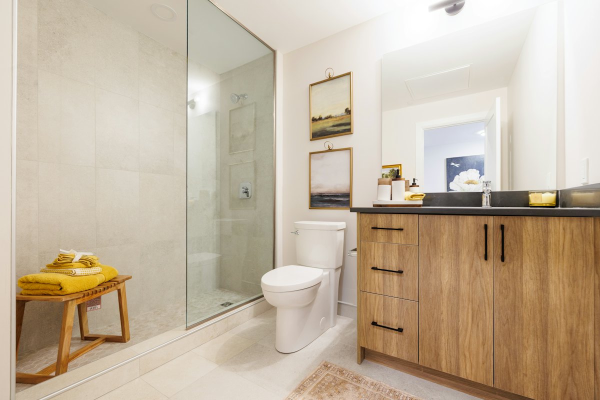 Spotless bathroom with a glass walk-in shower and wood vanity