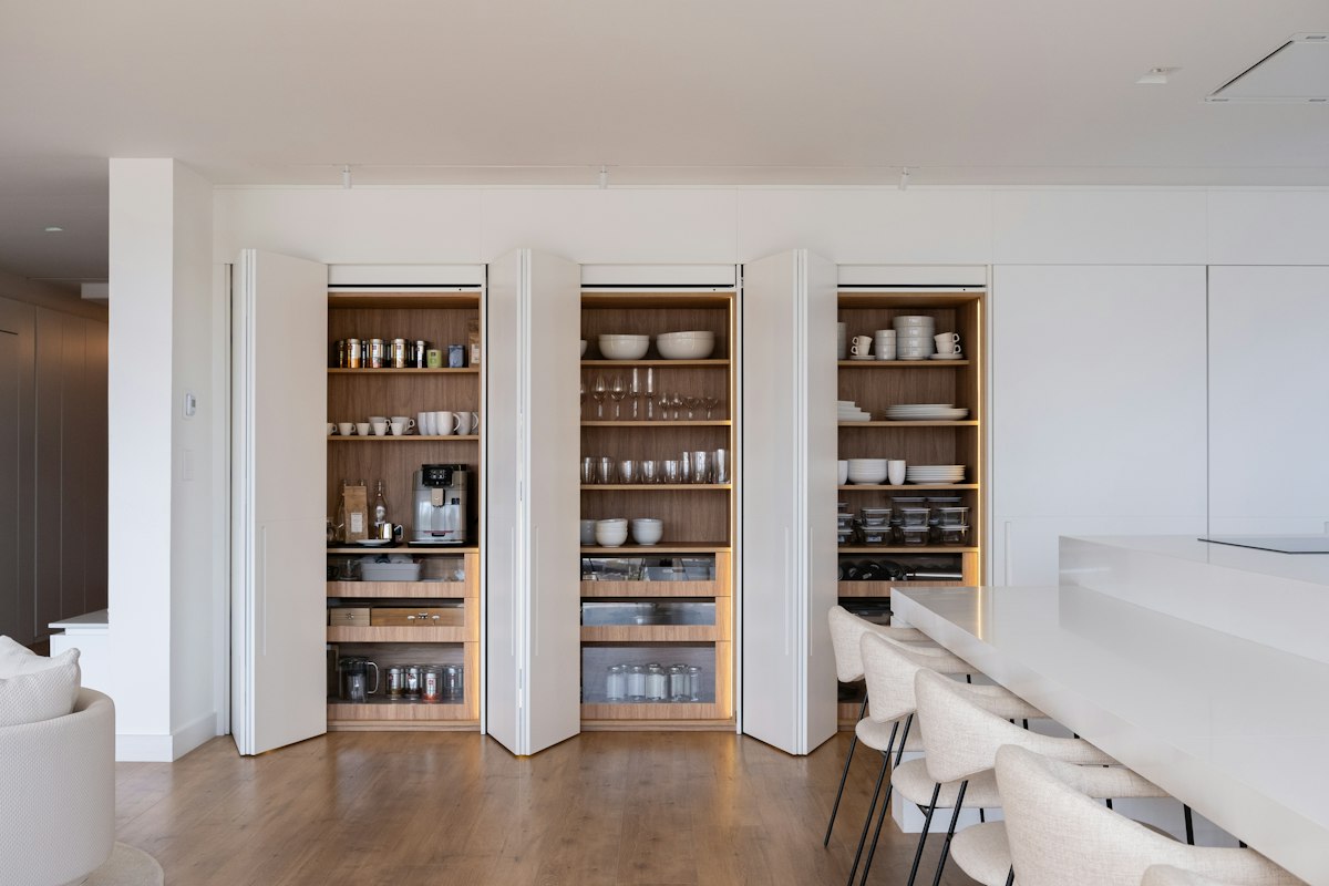 Organized walk-in pantry with tidy, well-stocked shelves